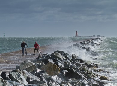 Cyclists brave the storm at The Great South Wall near Poolbeg.